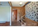 Inviting foyer with hardwood floors and staircase with accent wallpaper and paneling at 2905 Maryland Ave, Kannapolis, NC 28083