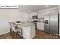 Kitchen island with granite countertop and stainless steel appliances at 2957 Penninger Cir, Charlotte, NC 28262