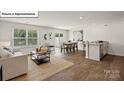 Open concept living and dining area with hardwood floors at 2957 Penninger Cir, Charlotte, NC 28262