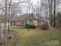 Lovely brick home featuring a well-manicured lawn and mature trees providing shade and curb appeal at 298 Upper Stanley Rd, Stanley, NC 28164