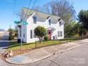 Two-story home on corner lot with a red door and well-maintained landscaping at 301 S Washington St, Monroe, NC 28112