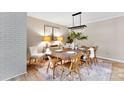 Dining room with a rustic wooden table and crystal chandelier at 3013 Southampton Cir, Gastonia, NC 28056