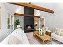 Living room with a cozy fireplace and exposed wooden beams at 3013 Southampton Cir, Gastonia, NC 28056