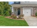 Townhome with a landscaped front yard and attached two-car garage at 33 Woodsdale Se Pl, Concord, NC 28025