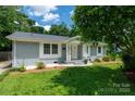 Charming single-story home featuring a well-manicured lawn, painted brick, and a welcoming front porch at 3531 Enfield Rd, Charlotte, NC 28205