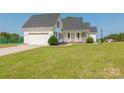 White two-car garage, front porch, and well-maintained lawn at 3624 Ramsey Rd, Sharon, SC 29742