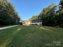 House exterior showcasing a large yard and driveway at 475 Cornerstone Dr, Taylorsville, NC 28681