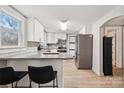 Bright, updated kitchen featuring stainless steel appliances, granite countertops, and a breakfast bar at 5483 Paulmo Dr, Charlotte, NC 28216