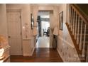 Bright entryway with hardwood floors and a view into the dining area at 5711 Falls Ridge Ln, Charlotte, NC 28269