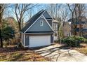 Gray two-story house with attached garage, viewed from the driveway at 6017 Millbury Ct # 16, Charlotte, NC 28211