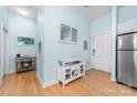 A bright entryway with hardwood floors, a white storage cabinet and a mirror on the wall at 780 N Davidson St, Charlotte, NC 28202