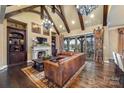 Spacious living room with vaulted ceilings, a fireplace, and leather furniture at 8128 Bayview Ln, Belmont, NC 28012