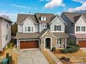 Charming two-story home with stone accents, a two-car garage, and a well-manicured front yard at 9730 Briarwick Ln, Charlotte, NC 28277