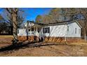 White single story home with covered porch and brick foundation at 10386 Turnplow Dr, Davidson, NC 28036