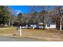 White single story home with covered porch, pool and detached garage at 10386 Turnplow Dr, Davidson, NC 28036