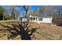 White single story home with covered porch and brick foundation at 10386 Turnplow Dr, Davidson, NC 28036