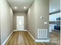 Bright entryway with light wood floors and a view of the kitchen at 1057 12Th Avenue Nw Dr, Hickory, NC 28601