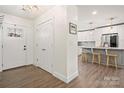 Welcoming entryway with hardwood floors, closet, and views of the modern, updated kitchen at 11400 Five Cedars Rd, Charlotte, NC 28226