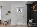 Bright entryway with white door and dark accent wall at 1213 Hartford Ave, Charlotte, NC 28209