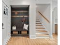 Modern entryway with built-in bench, storage, and stairs at 1213 Hartford Ave, Charlotte, NC 28209