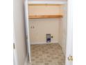 Small laundry room with built-in shelving and tile floor at 1243 Glory Ct, Oakboro, NC 28129