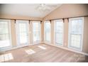 Bright sunroom featuring multiple windows and carpet flooring at 1243 Glory Ct, Oakboro, NC 28129