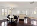 Bright dining room featuring hardwood floors and a glass-top table at 145 Ashton Woods Ct, Mount Holly, NC 28120