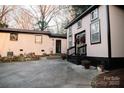 Exterior view of home with a concrete driveway, two buildings, mature trees, and seasonal decor, providing a welcoming ambiance at 1723 Oak St, Charlotte, NC 28269