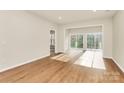 Bright living room featuring hardwood floors and a large window bringing in natural light at 17563 Hawks View Dr, Fort Mill, SC 29707