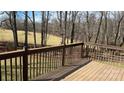 A wooden back deck overlooks the wooded backyard, offering a peaceful and private outdoor living space at 1790 Kathy St, Newton, NC 28658