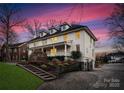 Two-story white house with a driveway and manicured lawn at 2240 Mecklenburg Ave, Charlotte, NC 28205