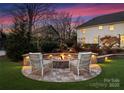 Cozy fire pit area with comfortable seating and stonework at 2240 Mecklenburg Ave, Charlotte, NC 28205