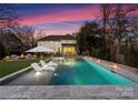 Stunning rectangular pool with swim-up seating and ambient lighting at 2240 Mecklenburg Ave, Charlotte, NC 28205