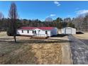 Single story home with red metal roof and detached garage, aerial view at 291 Patterson Farm Rd, Mooresville, NC 28115