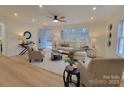 Light filled living room with L-shaped sofa, hardwood floors, and large windows at 301 W Hartford Ave, Bessemer City, NC 28016