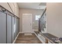 Entryway with coat rack on the left and carpeted stairs on the right and wood flooring at 3575 Cerelia Ln, Denver, NC 28037