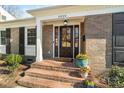 Close-up of the front entrance featuring a beautiful brick facade, a cozy stoop and a stylish front door at 3939 Sussex Ave, Charlotte, NC 28210