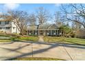 Inviting single-story home with a well-maintained lawn, mature trees, and a spacious driveway at 3939 Sussex Ave, Charlotte, NC 28210