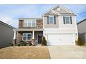 Two-story house with stone and siding, two-car garage, and landscaping at 4134 Richard Andrew Dr, Matthews, NC 28105