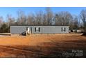 Gray mobile home with brick skirting, steps, and a small yard at 426 Sellerstown Rd, Kings Mountain, NC 28086