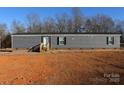 Gray mobile home with brick skirting, steps, and a small yard at 426 Sellerstown Rd, Kings Mountain, NC 28086