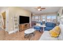 Cozy living room with hardwood floors, a fireplace, and comfortable seating at 4301 Windjammer Sw Ct, Concord, NC 28027