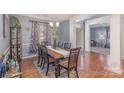 Dining room with hardwood floors, modern chandelier, and elegant curtains at 4763 Brockton Nw Ct, Concord, NC 28027