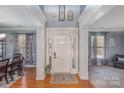 Inviting foyer featuring hardwood floors, elegant columns, and natural light streaming through the front door at 4763 Brockton Nw Ct, Concord, NC 28027