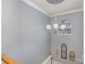 Stairwell with light gray walls, white chandelier and trim at 4763 Brockton Nw Ct, Concord, NC 28027