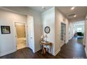 Bright hallway featuring hardwood floors, neutral walls, and access to a bathroom and office at 5047 Summer Surprise Ln, Charlotte, NC 28215