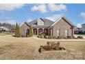 Brick home with landscaped yard, large windows and a welcoming porch at 573 Church St, Locust, NC 28097