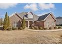 Brick home with landscaped yard, large windows and a welcoming porch at 573 Church St, Locust, NC 28097