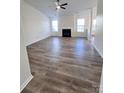 Spacious living room featuring a ceiling fan and fireplace at 6140 Whispering Brook Ct, Charlotte, NC 28216