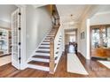 Spacious foyer with hardwood floors, a staircase, and views into the living spaces at 7191 Three Kings Rd, Fort Mill, SC 29715